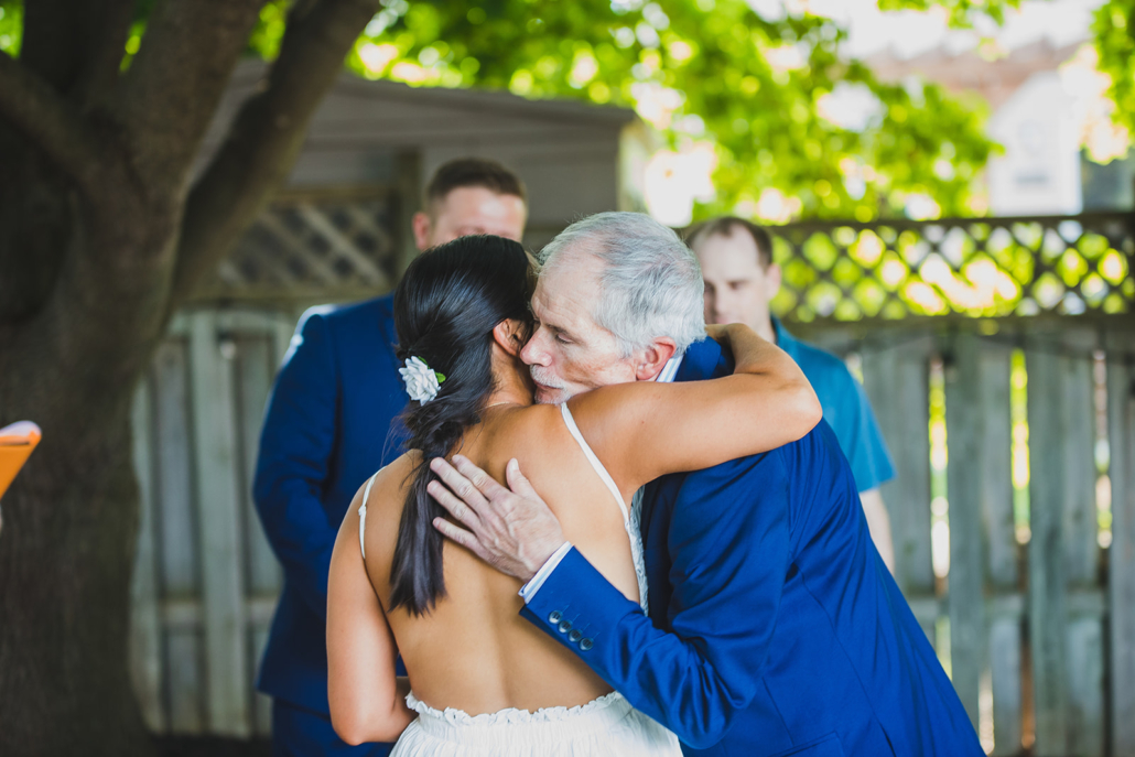 father hugging bride