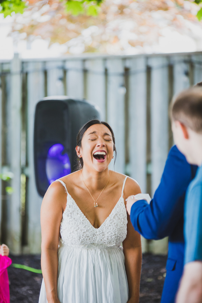 bride laughing at groom's wedding vows