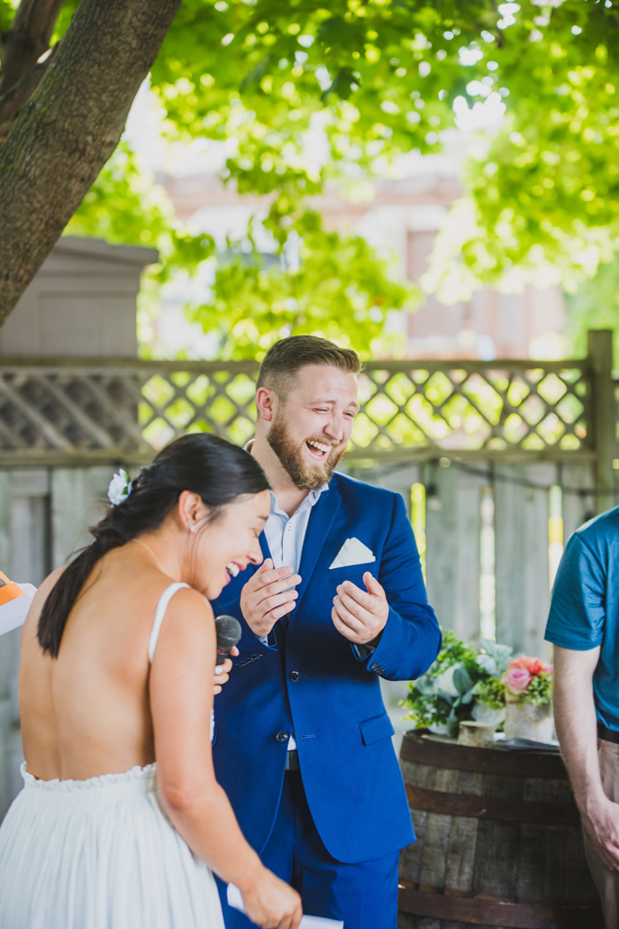 groom laughing at bride's vows