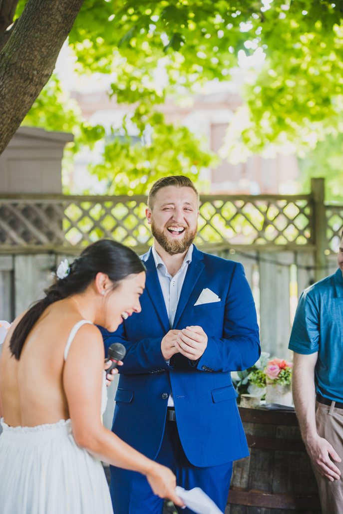 groom laughing at bride's vows
