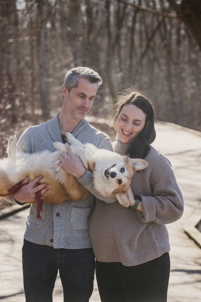 a couple and their corgi in maternity photos