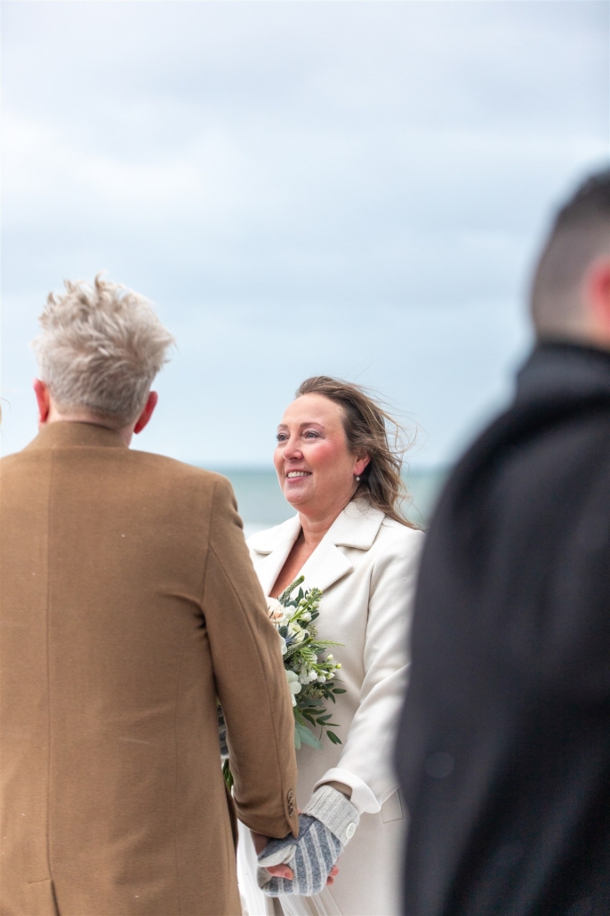 bride looking at groom in winter wedding ceremony